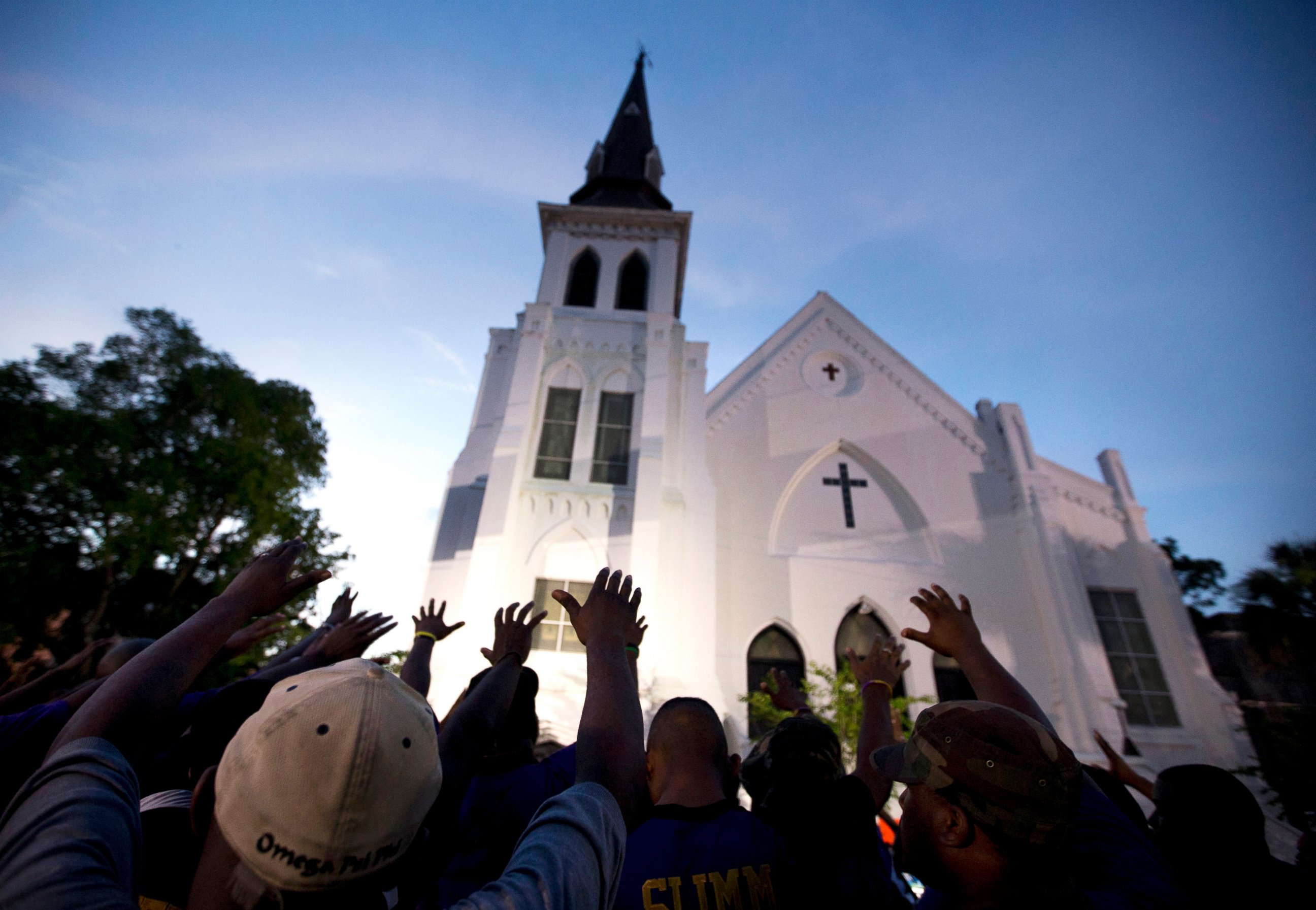 PHOTO: In this June 19, 2015, file photo, the men of Omega Psi Phi Fraternity Inc. lead a crowd of people in prayer outside the Emanuel AME Church, after a memorial service for the nine people killed by Dylann Roof in Charleston, S.C.
