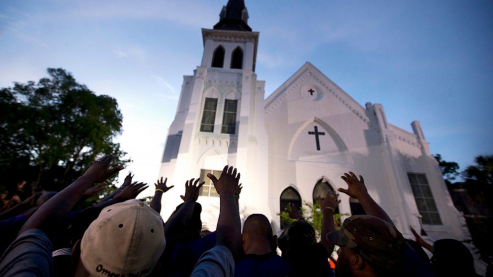 PHOTO: In this June 19, 2015, file photo, the men of Omega Psi Phi Fraternity Inc. lead a crowd of people in prayer outside the Emanuel AME Church, after a memorial service for the nine people killed by Dylann Roof in Charleston, S.C.