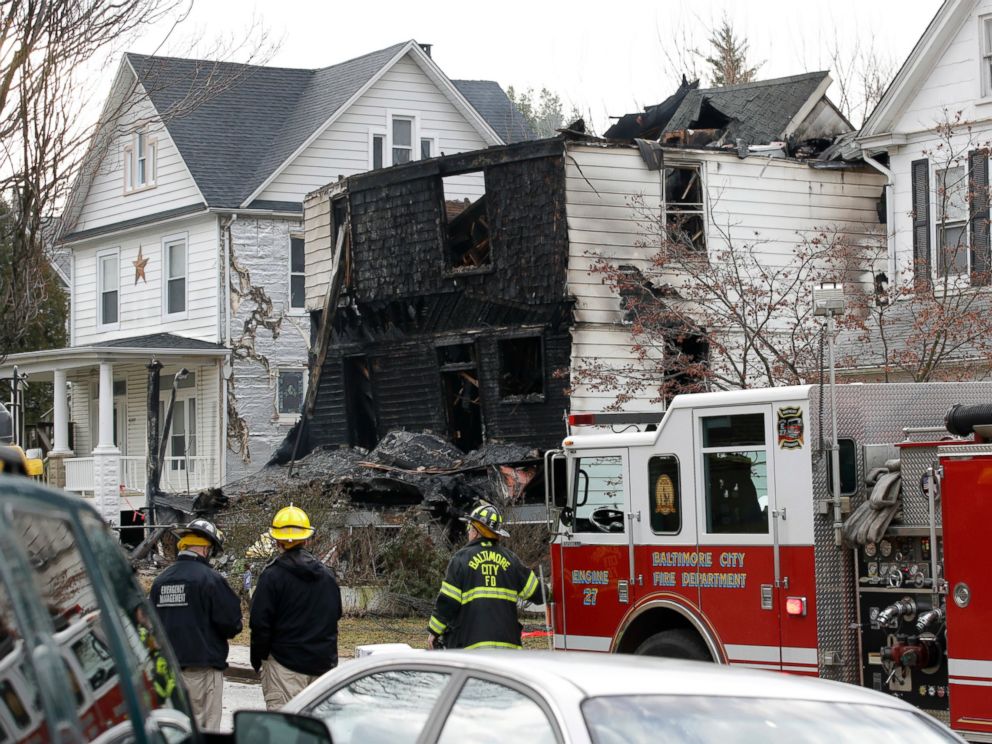 PHOTO: Fire officials stand at the scene of an early morning house fire in Baltimore, Jan. 12, 2017.