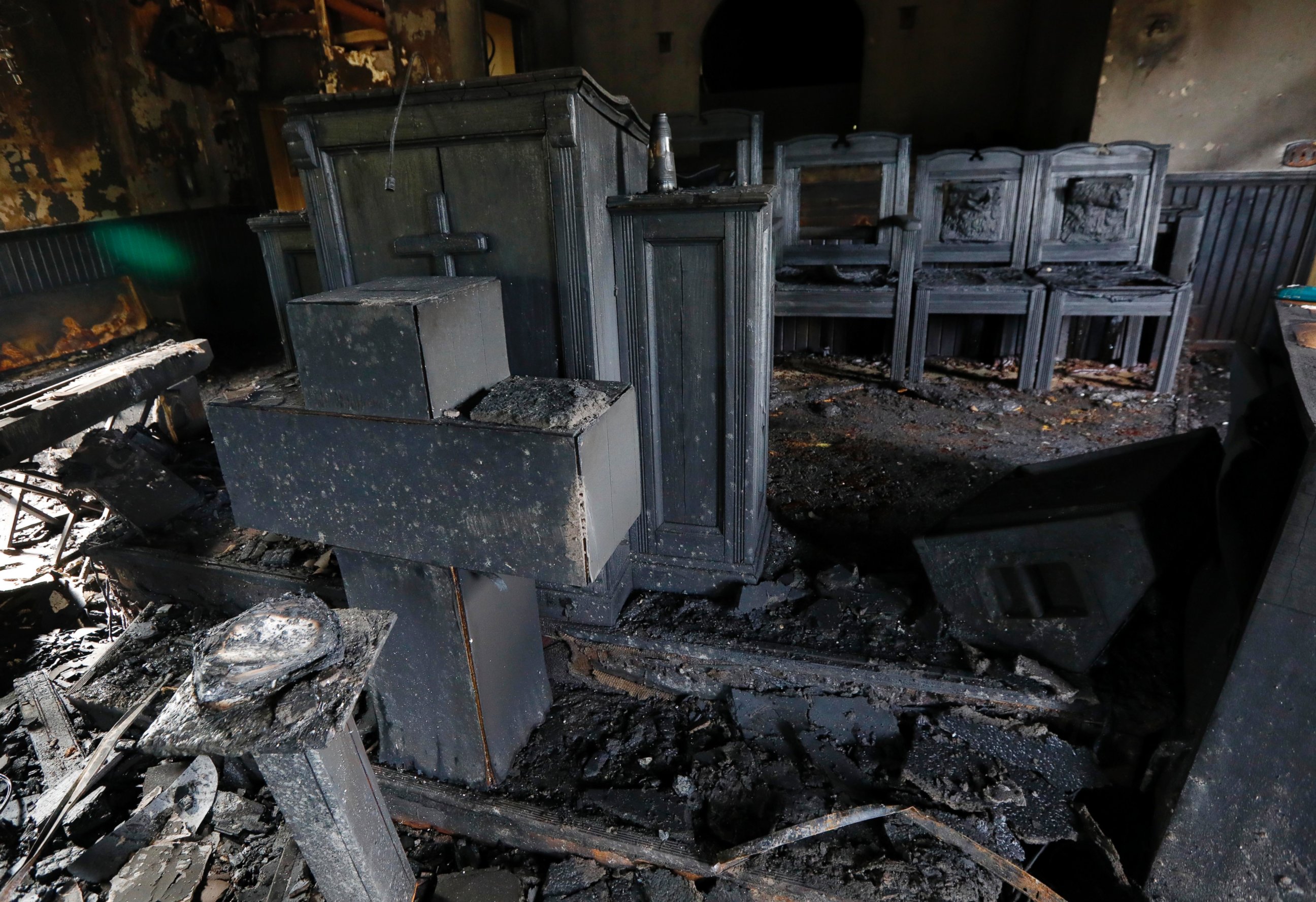 PHOTO: Burned pews, destroyed musical instruments, Bibles and hymnals are part of the debris inside the fire damaged Hopewell M.B. Baptist Church in Greenville, Mississippi, Nov. 2, 2016.