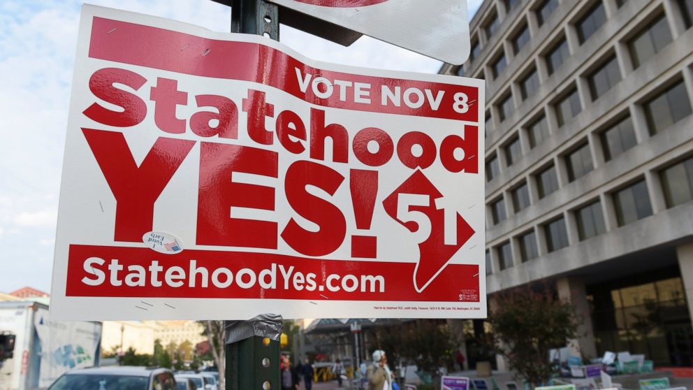 Signs supporting DC statehood are on display outside an early voting place on in Washington, on Nov. 3, 2016. 