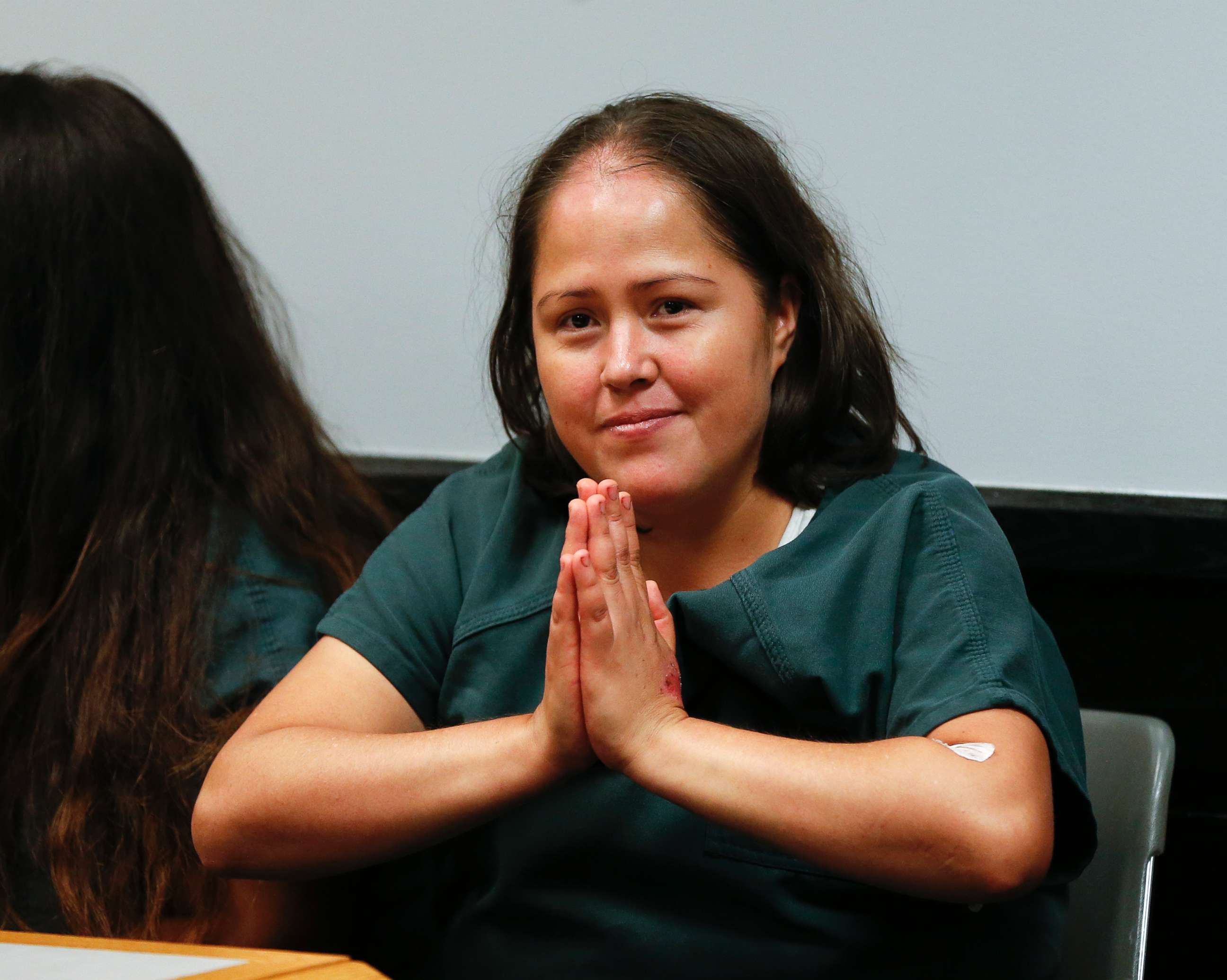PHOTO: Isabel Martinez gestures towards news cameras during her first court appearance, July 7, 2017, in Lawrenceville , Ga. Martinez is charged with killing four of her children and their father. 