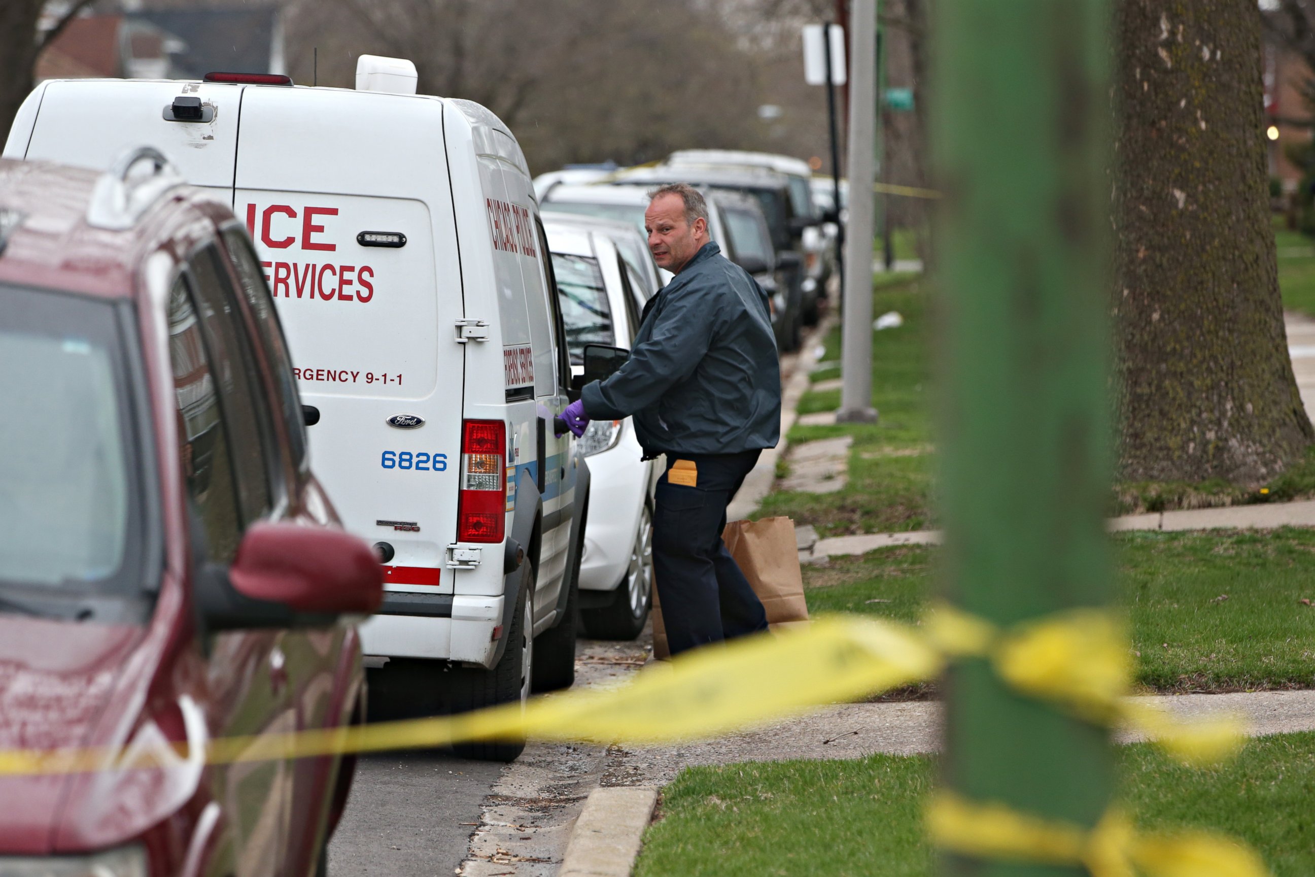 PHOTO: An investigator opens the door of a vehicle outside a home on the South Side of Chicago, April 10, 2017, after Cook County Circuit Court Raymond Myles was shot to death outside his home.