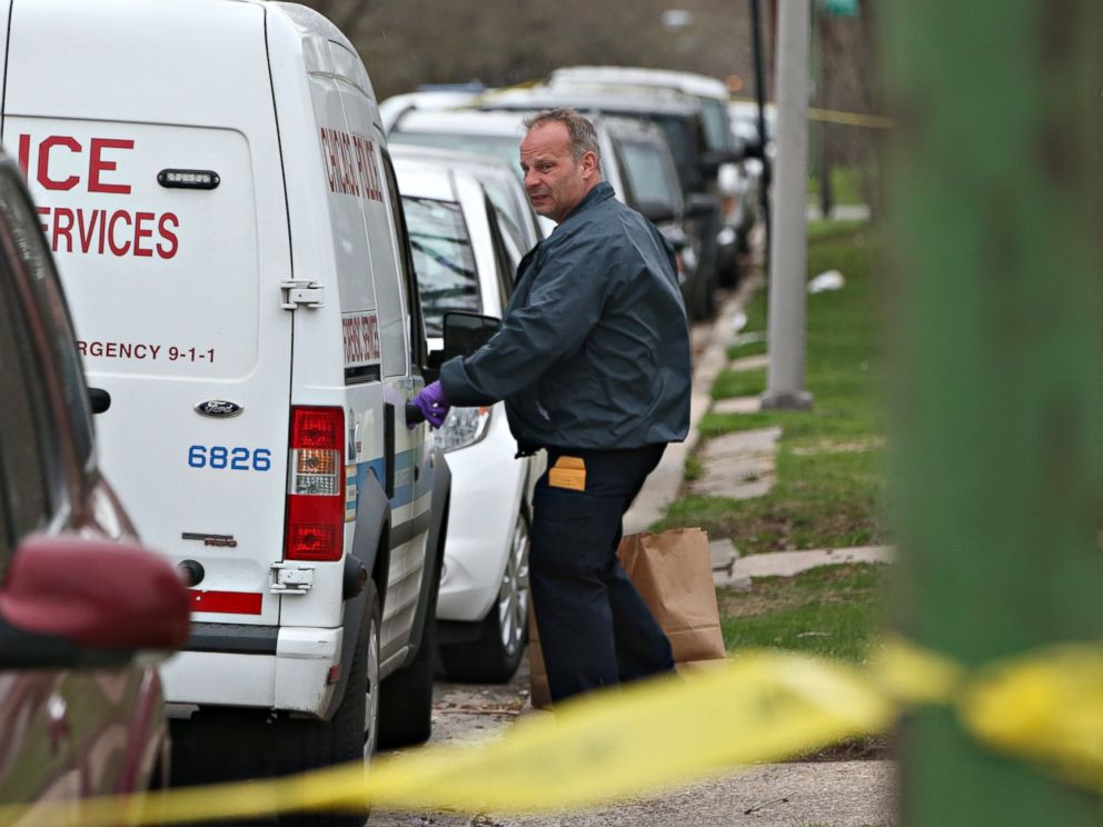 PHOTO: An investigator opens the door of a vehicle outside a home on the South Side of Chicago, April 10, 2017, after Cook County Circuit Court Raymond Myles was shot to death outside his home.