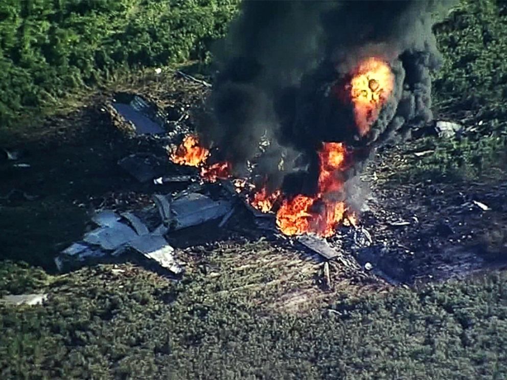PHOTO: Smoke and flames rise from a military plane that crashed in a farm field, in Itta Bena, Miss., killing several.