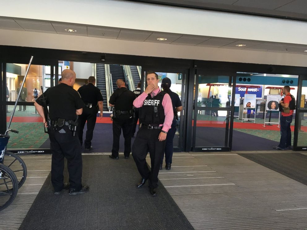 PHOTO: Police officers gather at a terminal at Bishop International Airport, June 21, 2017, in Flint, Mich.