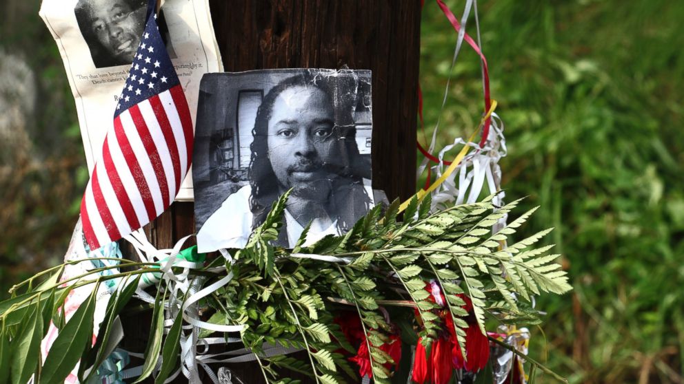 PHOTO: In this July 29, 2015, file photo, photos of Sam DuBose hang on a pole at a memorial near where he was shot and killed by a University of Cincinnati police officer during a July 19, 2015, traffic stop in Cincinnati. 
