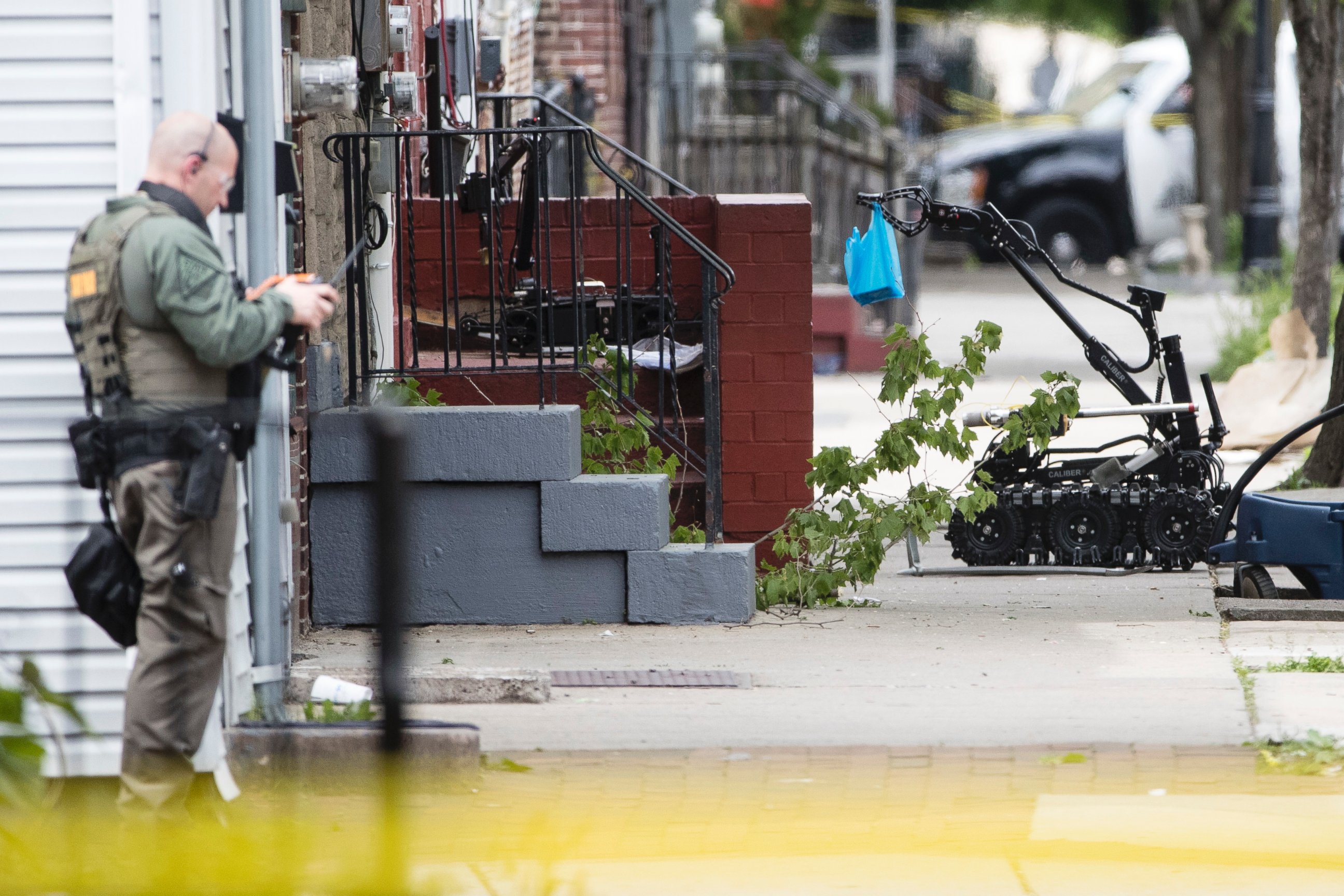 PHOTO: A police officer operates a robot during a standoff with a man in a home in Trenton, N.J., on May 10, 2017. 
