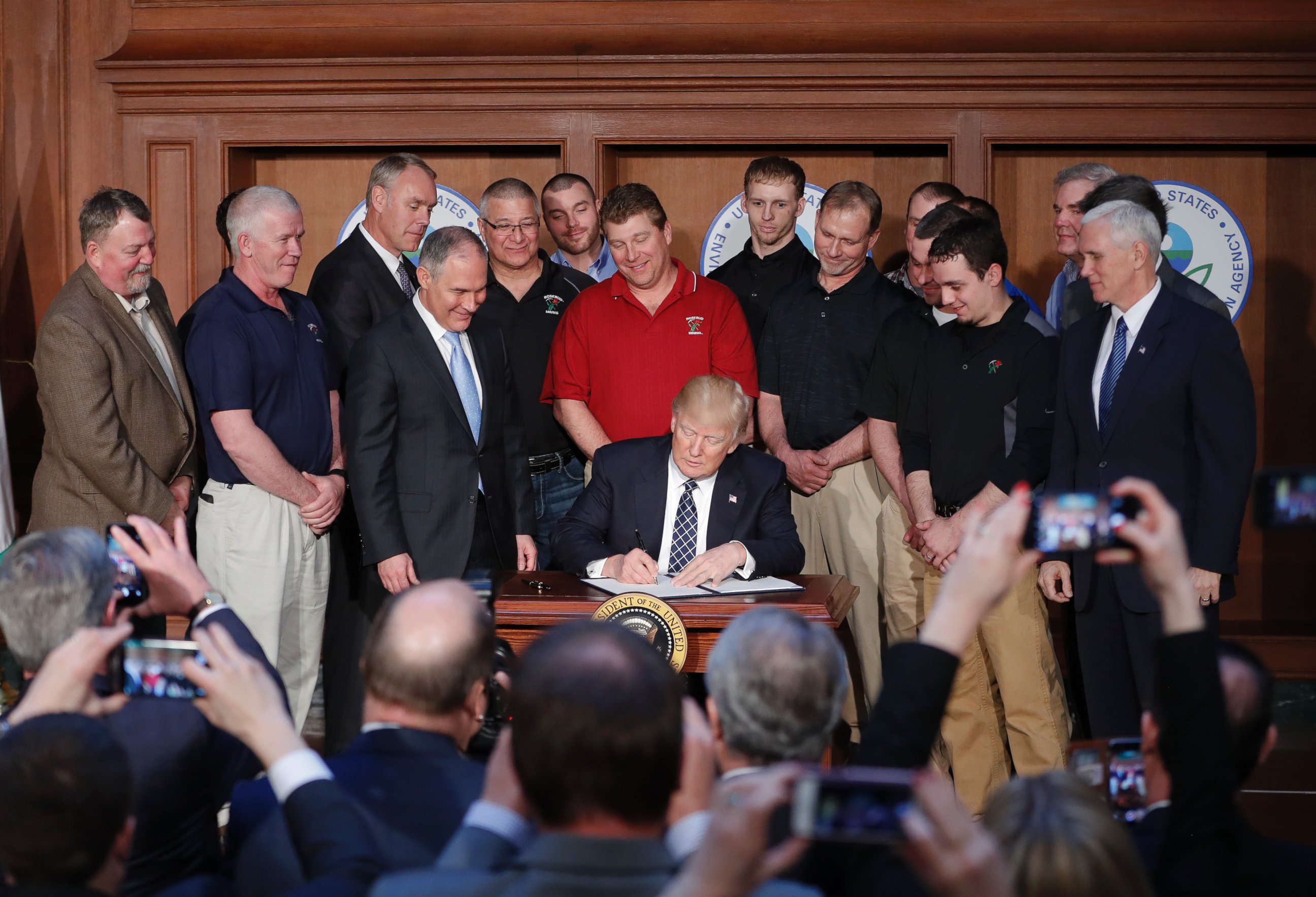 PHOTO: President Donald Trump, accompanied by Environmental Protection Agency (EPA) Administrator Scott Pruitt, third from left, signs an Energy Independence Executive Order, March 28, 2017, at EPA headquarters in Washington. 