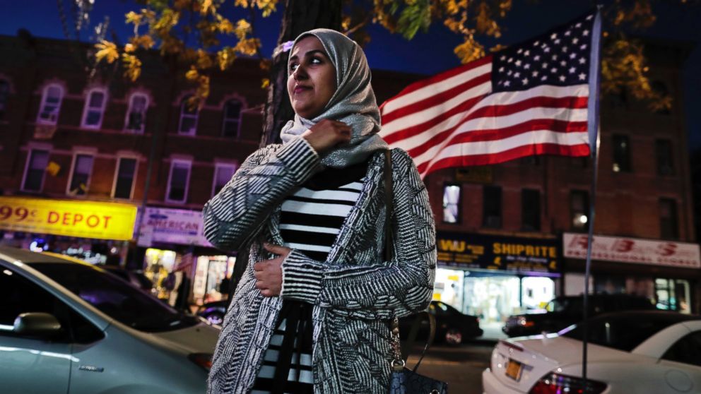 Enas Almadhwahi, an immigration outreach organizer for the Arab American Association of New York, stands for a photo along Fifth Avenue in the Bay Ridge neighborhood of Brooklyn, Nov. 11, 2016, in New York. 