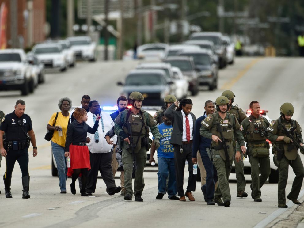 PHOTO: Police officers escort hostages safely across the street after a gunman held them during an attempted robbery at Community First Credit Union, Dec. 1, 2016, in Jacksonville, Florida.