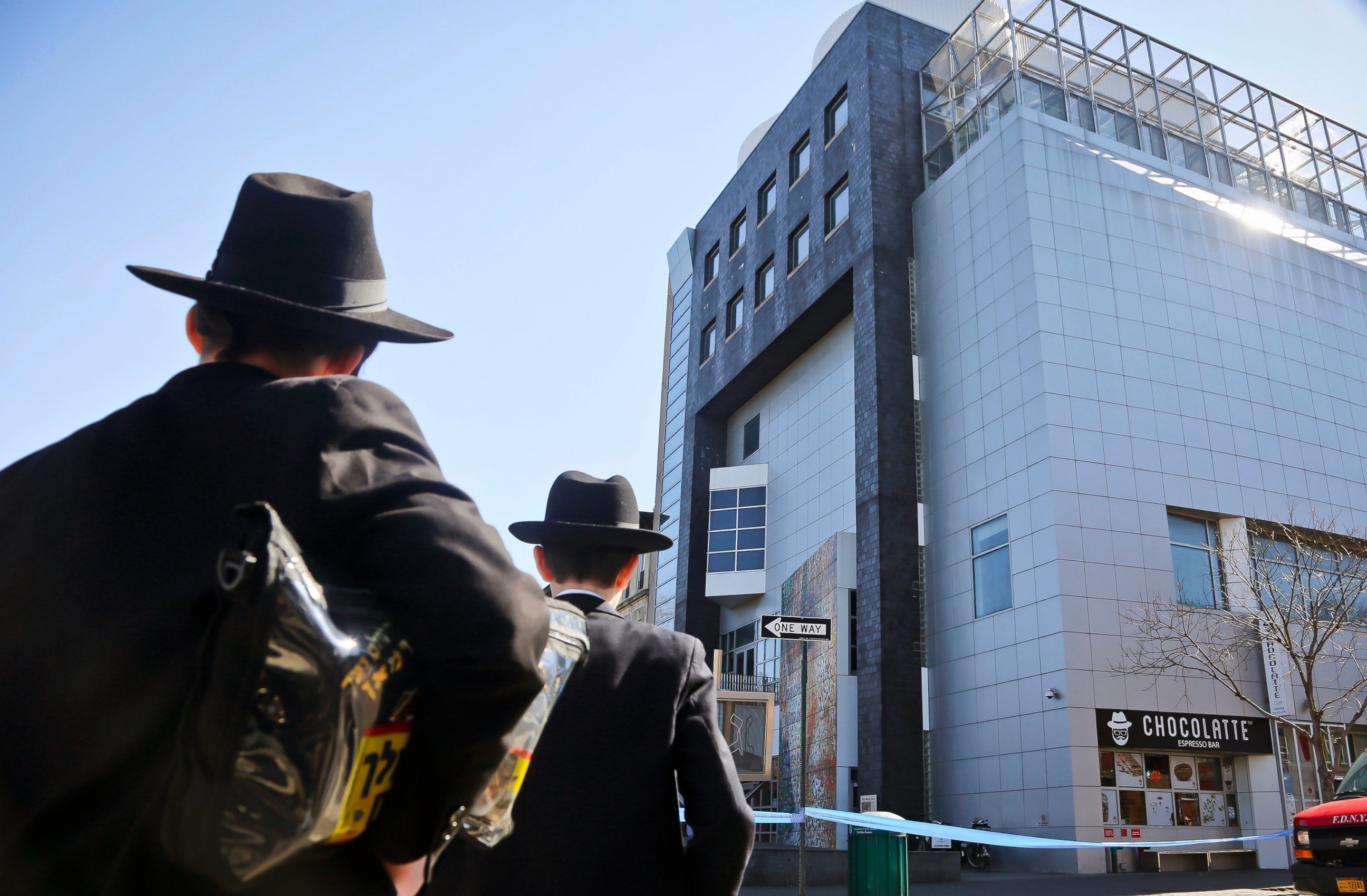 PHOTO: Two young men who left a nearby synagogue watch police activity outside the Jewish Children's Museum following a bomb threat in Brooklyn borough of New York, March 9, 2017.