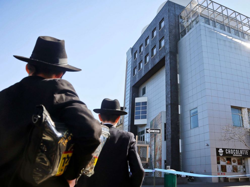 PHOTO: Two young men who left a nearby synagogue watch police activity outside the Jewish Childrens Museum following a bomb threat in Brooklyn borough of New York, March 9, 2017.
