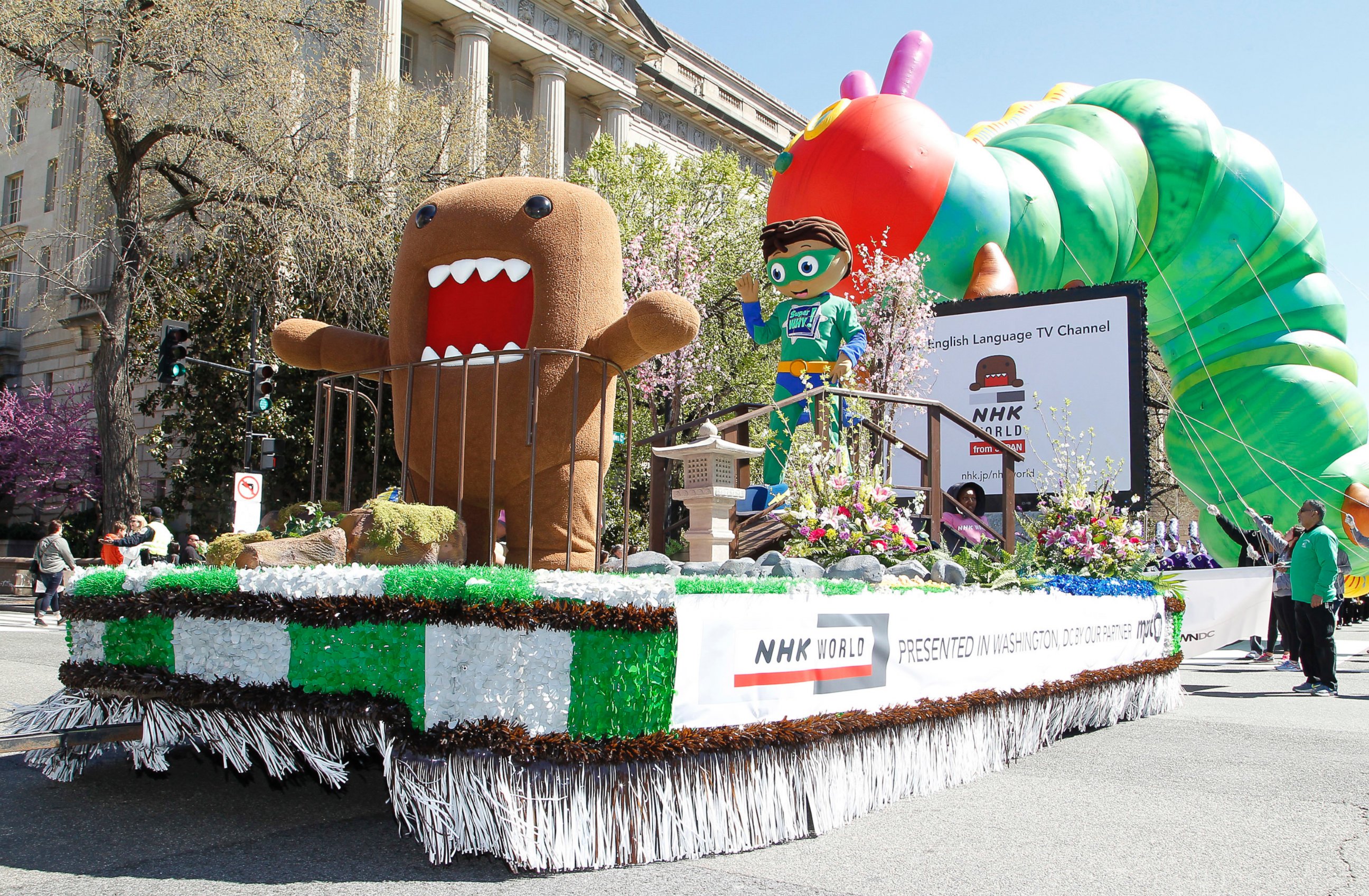 PHOTO: NHK WORLD TV's mascot Domo, left, and PBS Kids animated TV series character, Super Why!, right, on NHK WORLD TV's float during The National Cherry Blossom Festival Parade, April 8, 2017 in Washington. 