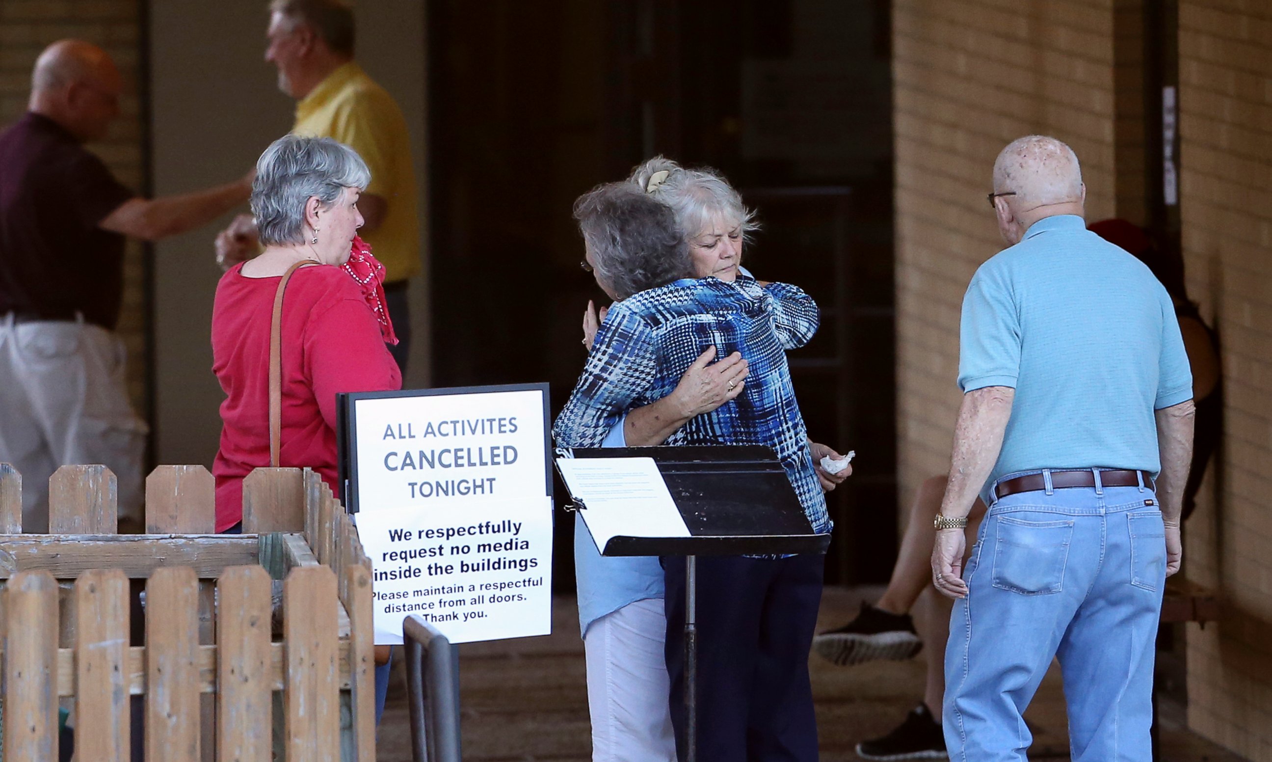 PHOTO: People greet each other outside First Baptist Church after hearing news of the deaths of several members who attended the church in New Braunfels, Texas, March 29, 2017.