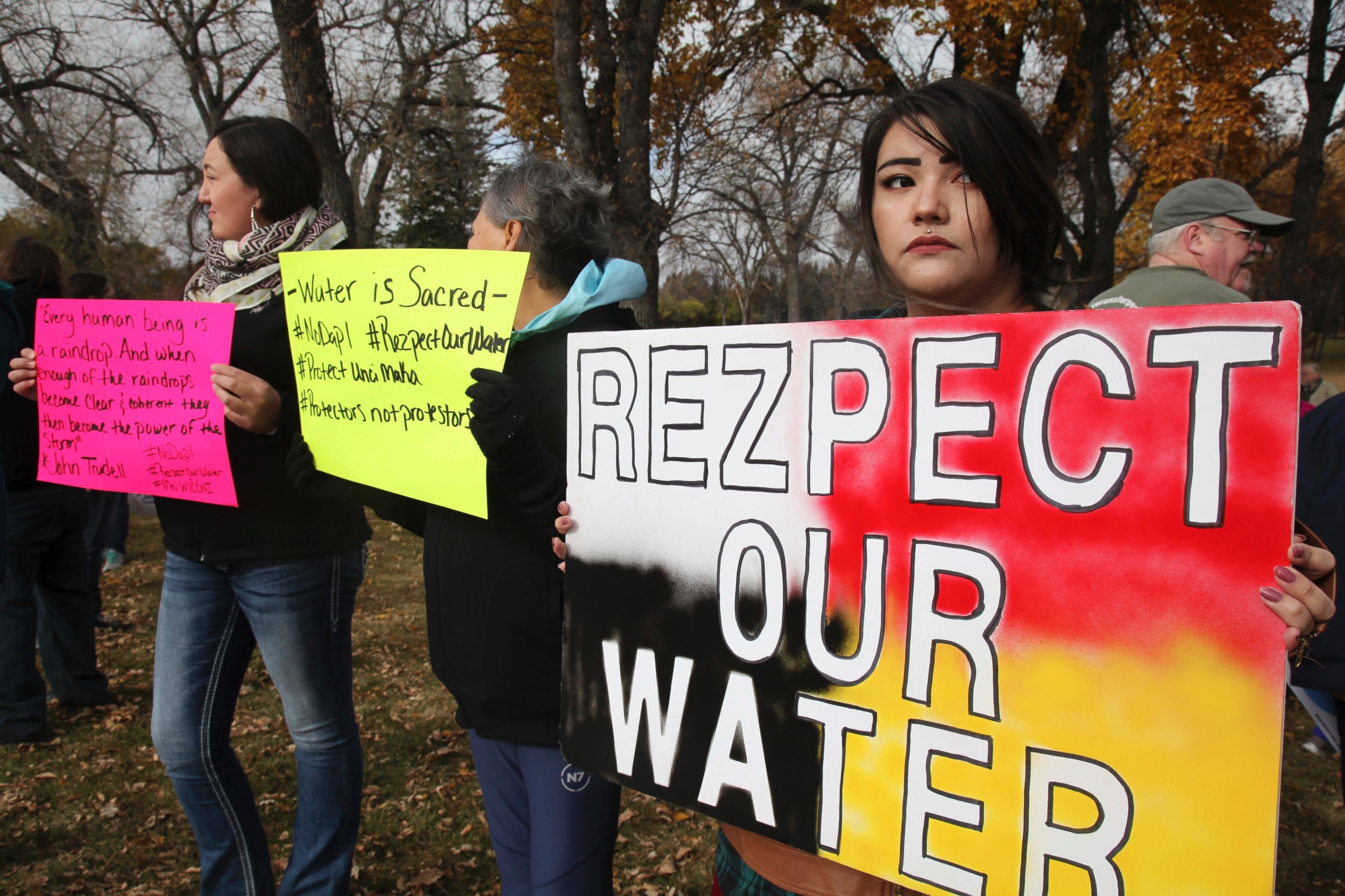 PHOTO: Holly Doll, of Mandan, an enrolled member of the Standing Rock Sioux Tribe, holds a protest sign outside the state's capitol building in Bismarck, N.D., Oct. 29, 2016. 