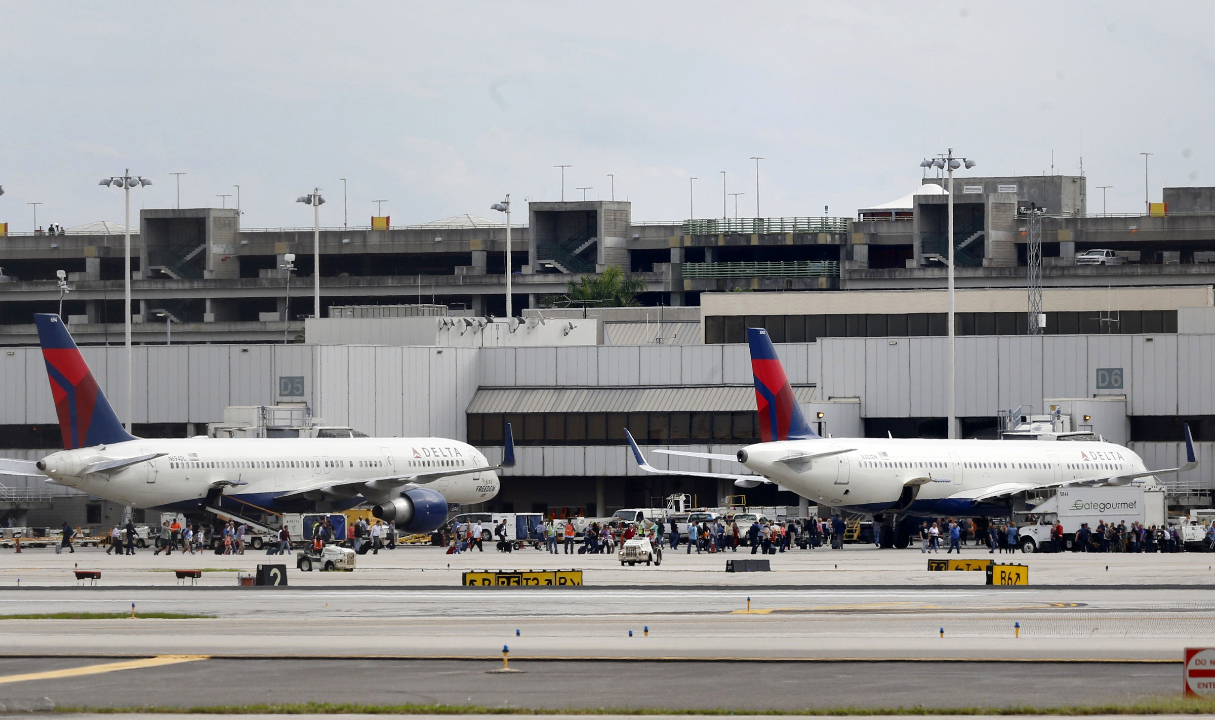 PHOTO: People stand on the tarmac at the Fort Lauderdale-Hollywood International Airport after a shooter opened fire inside a terminal of the airport, Jan. 6, 2017, in Fort Lauderdale, Fla.