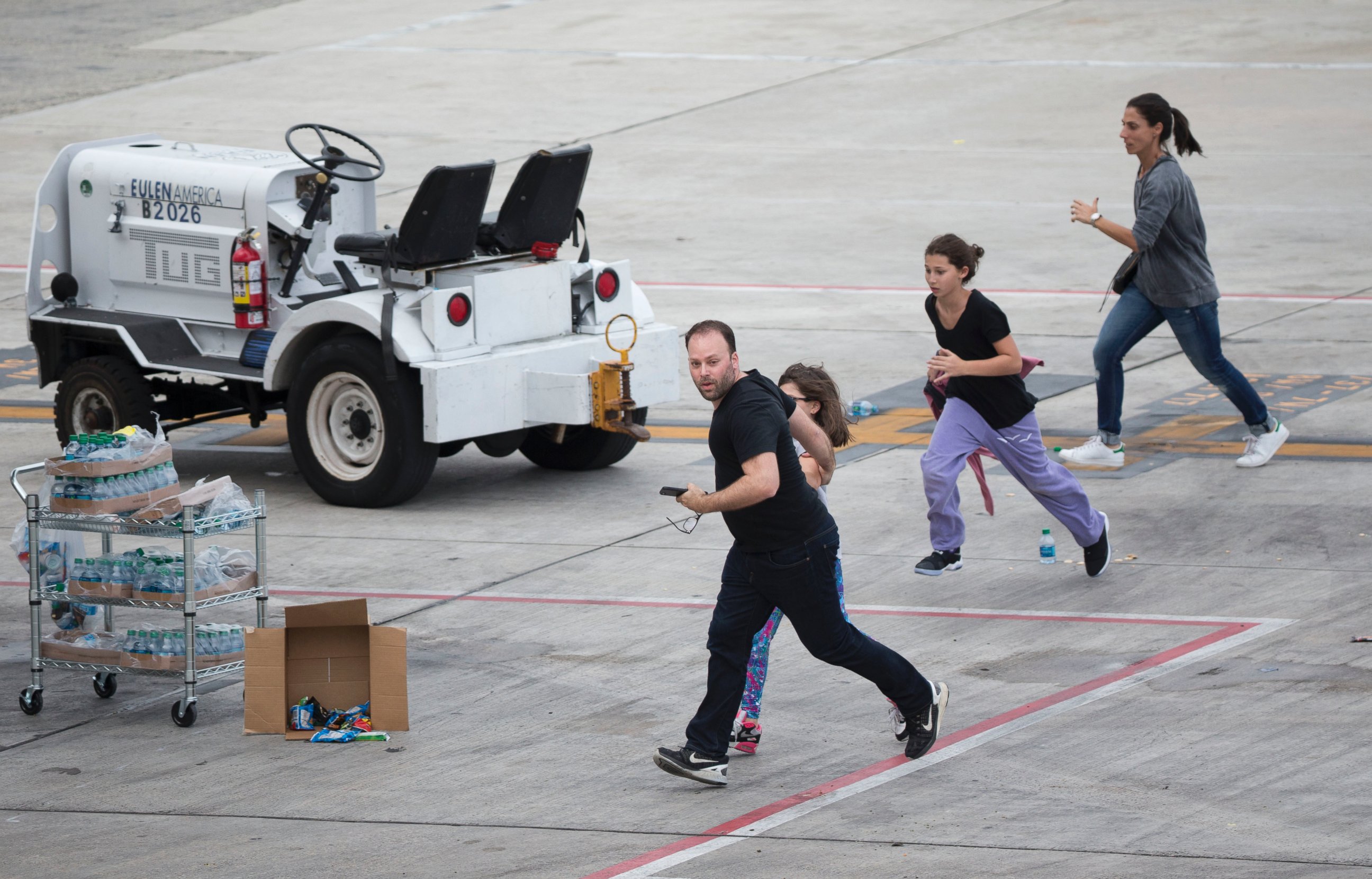PHOTO: People run on the tarmac at Fort Lauderdale-??Hollywood International Airport, Jan. 6, 2017, in Fort Lauderdale, Flordia, after a shooter opened fire inside a terminal of the airport.