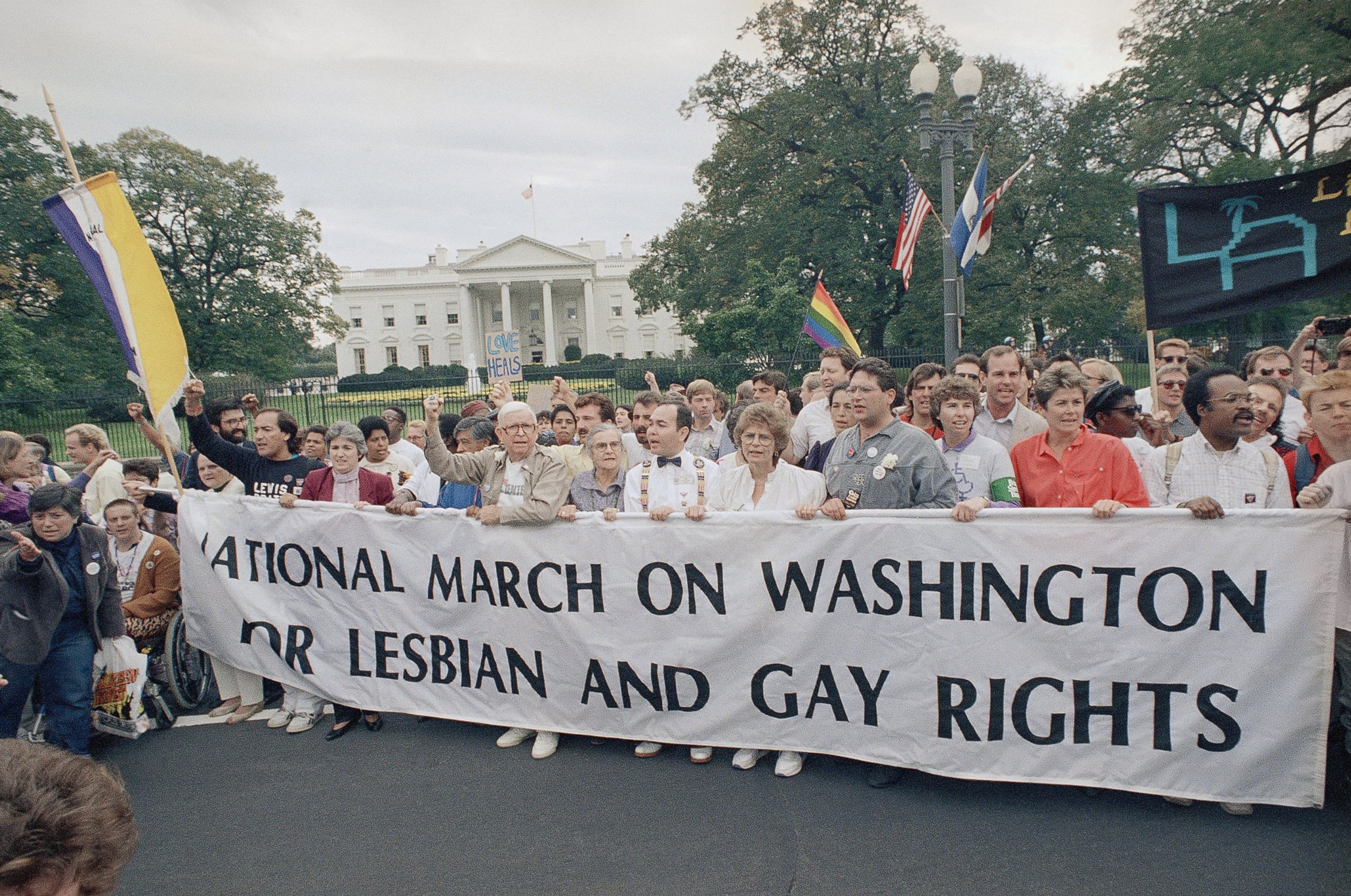PHOTO: Participants of the National March on Washington for Lesbian and Gay Rights carry a banner as they parade in front of the White House, Oct. 11, 1987, in Washington.