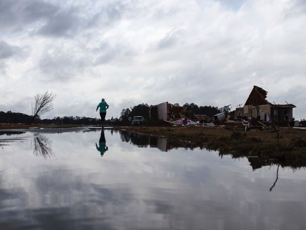 PHOTO: Marilyn Bullard makes her way to her parents home that was damaged by a tornado, Jan. 22, 2017, in Adel, Georgia.