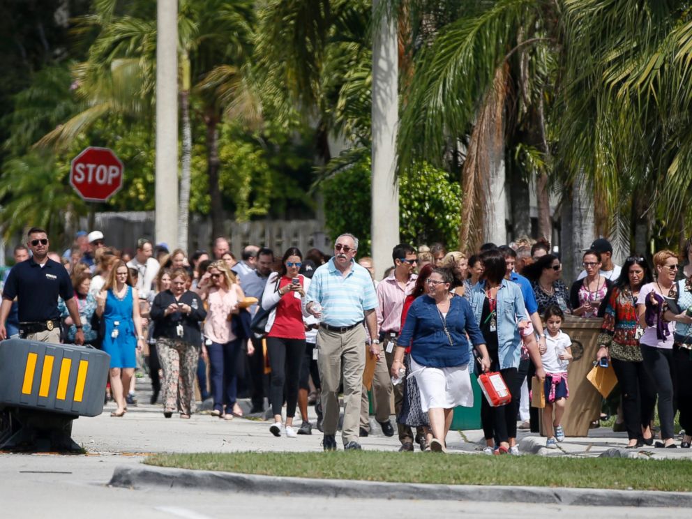 PHOTO: People evacuated because of a bomb threat return to the David Posnack Jewish Community Center and David Posnack Jewish Day School, Feb. 27, 2017, in Davie, Fla.