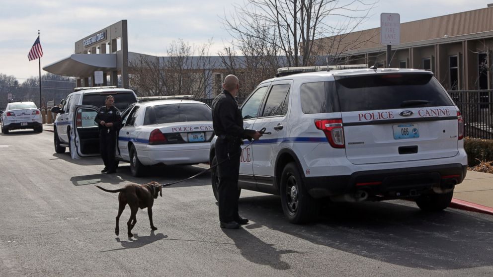 Police officers stand by as adults and children return to St. Louis Jewish Community Center, Jan. 18, 2017, in St. Louis after canine units cleared the building. According to St. Louis County Police, someone called the front desk claiming a device was inside. 