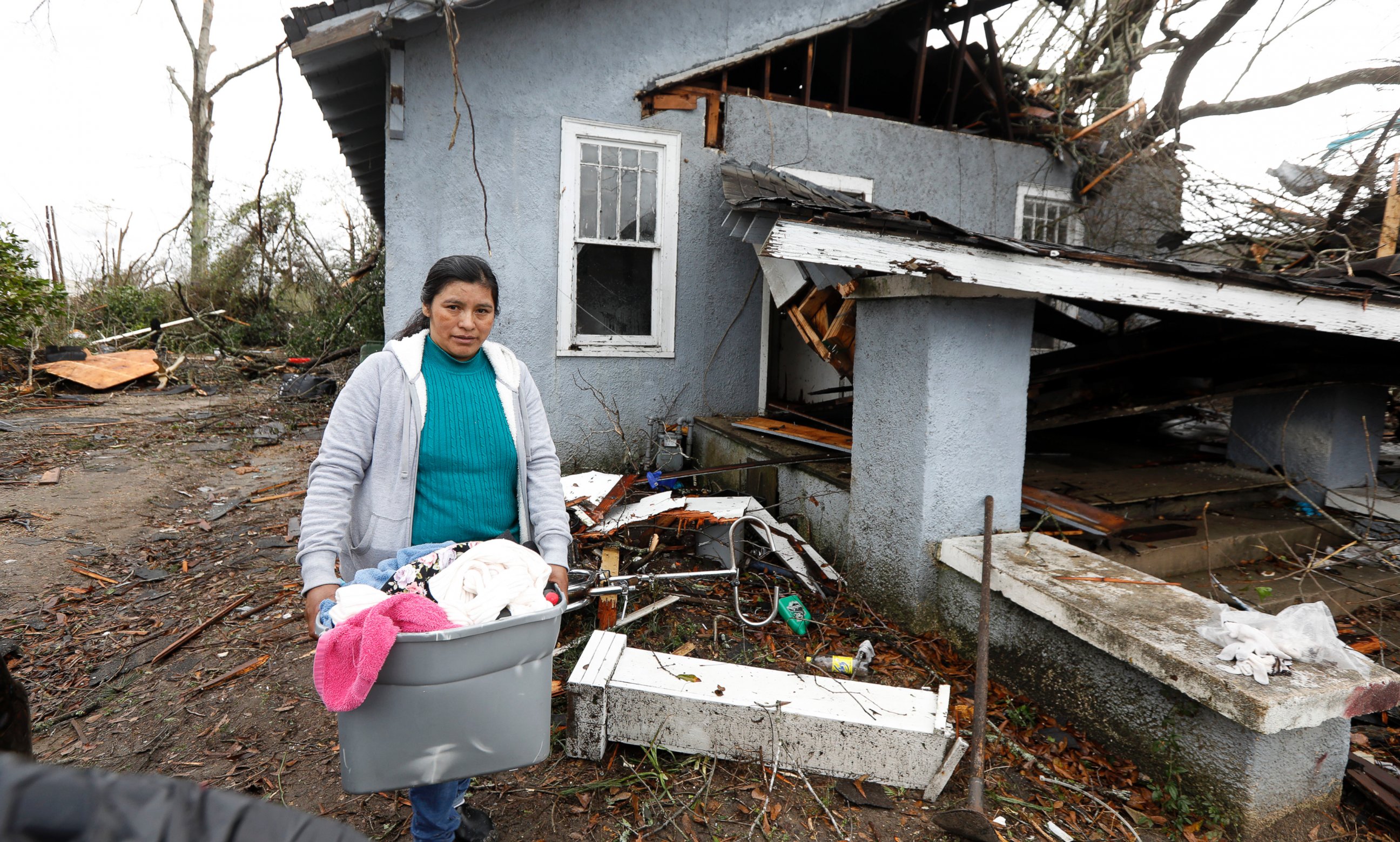 PHOTO: Margarita Morales carries her possessions out of a house she shared with two other people after a tornado destroyed the residence, Jan. 21, 2017 in Hattiesburg, Mississippi.