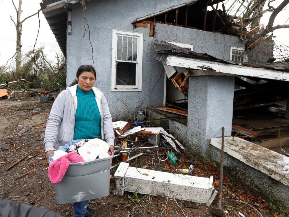 PHOTO: Margarita Morales carries her possessions out of a house she shared with two other people after a tornado destroyed the residence, Jan. 21, 2017 in Hattiesburg, Mississippi.