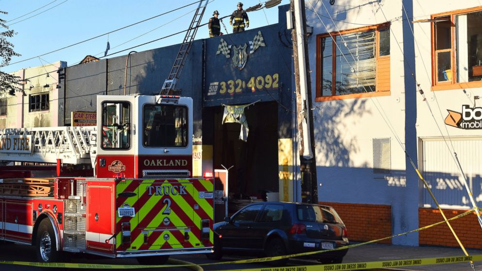 PHOTO: Firefighters assess the scene where a fire tore through a warehouse party, Dec. 3, 2016 in Oakland, California.