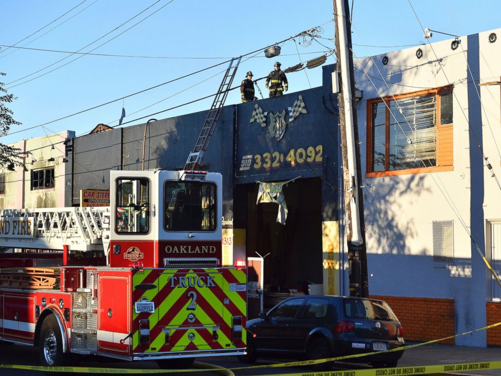 PHOTO: Firefighters assess the scene where a fire tore through a warehouse party, Dec. 3, 2016 in Oakland, California.