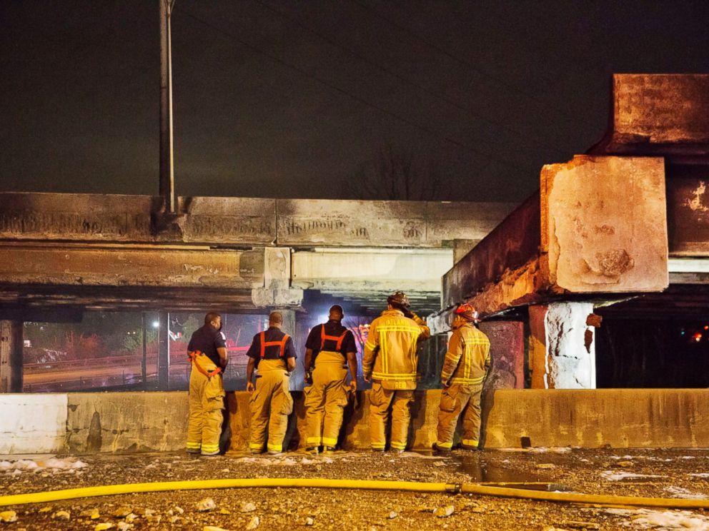 PHOTO: Firefighters survey the section of an overpass that collapsed from a large fire on Interstate 85 in Atlanta, March 30, 2017.