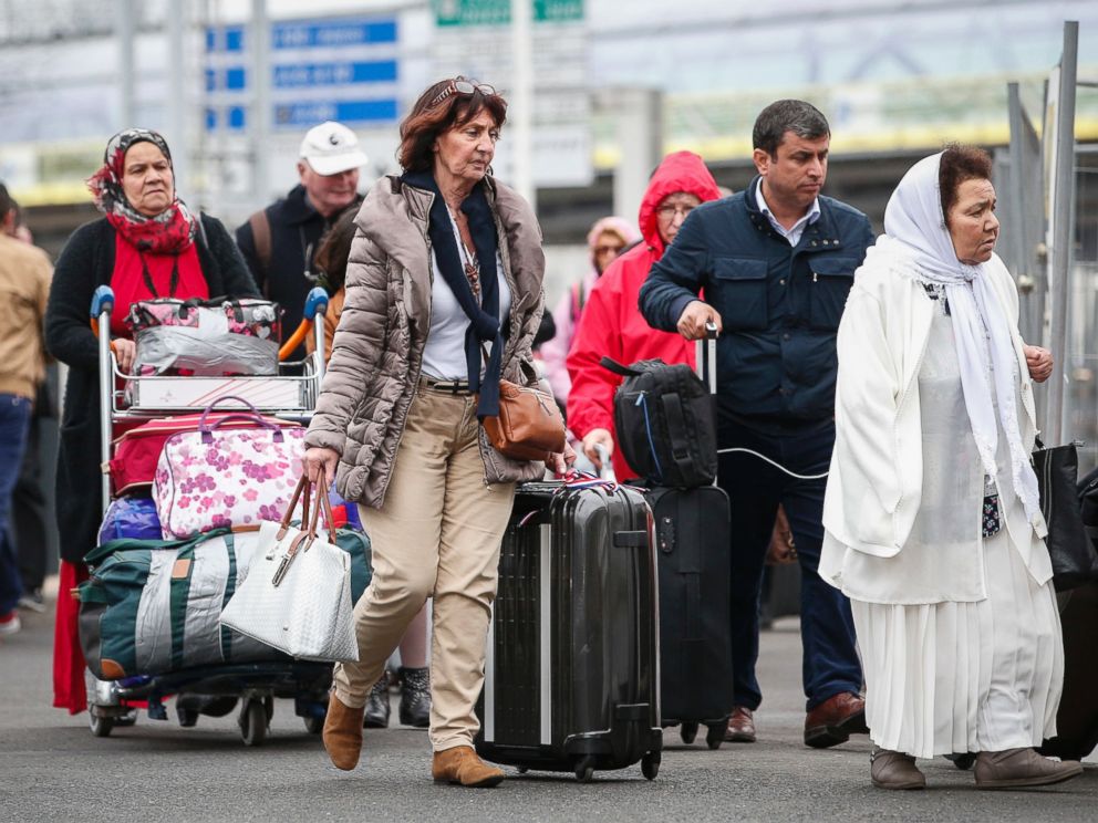 PHOTO: Travelers are walking back to Orly airport, south of Paris, as flights are gradually resuming, March, 18, 2017.