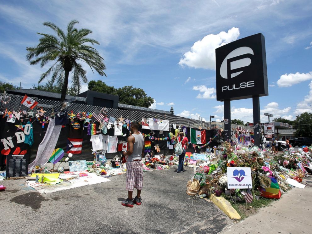 PHOTO: In this July 11, 2016, file photo, visitors at a makeshift memorial outside the Pulse nightclub, the day before the one month anniversary of the mass shooting, in Orlando, Fla.