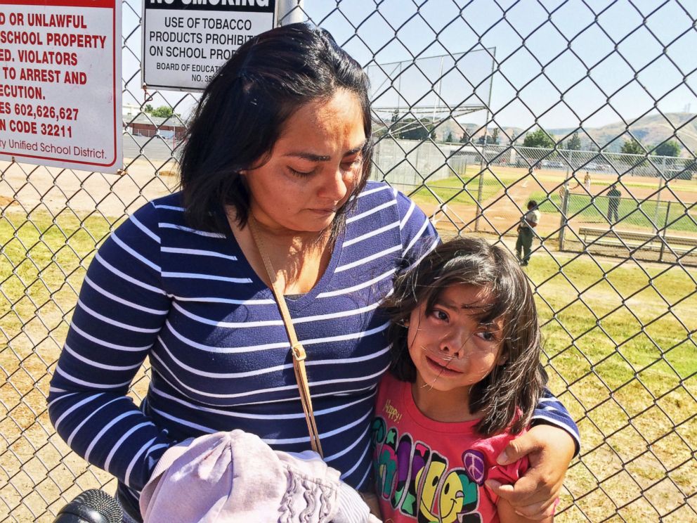 PHOTO: Elizabeth Barajas hugs her daughter, Marissa Perez, 9, following their reunion as Marissa recounted her experiences being in the classroom in which her teacher was shot to death at North Park Elementary School in San Bernardino, Calif.