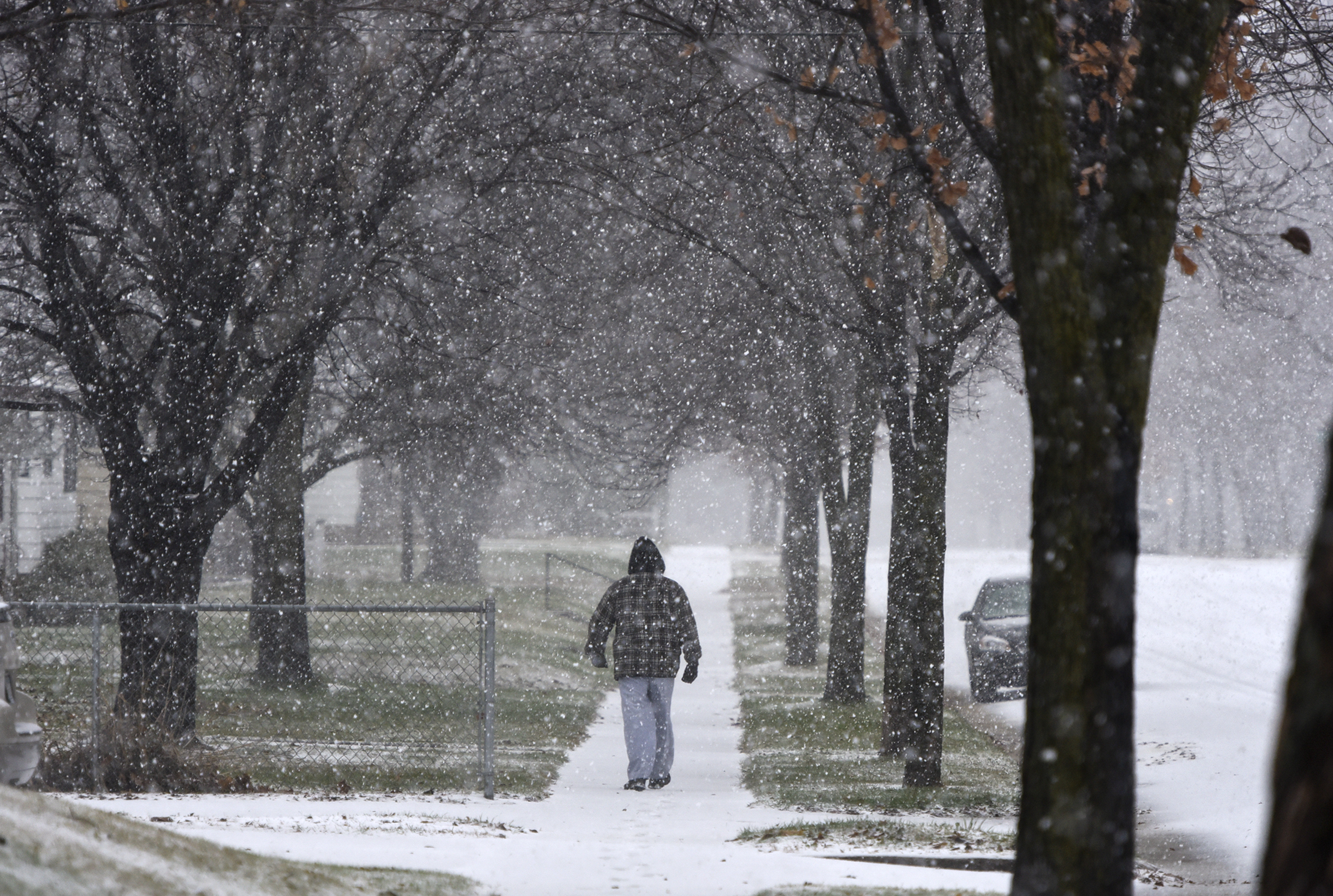 PHOTO: A man walks during a snow storm, Nov. 18, 2016, in St. Cloud, Minnesota. 