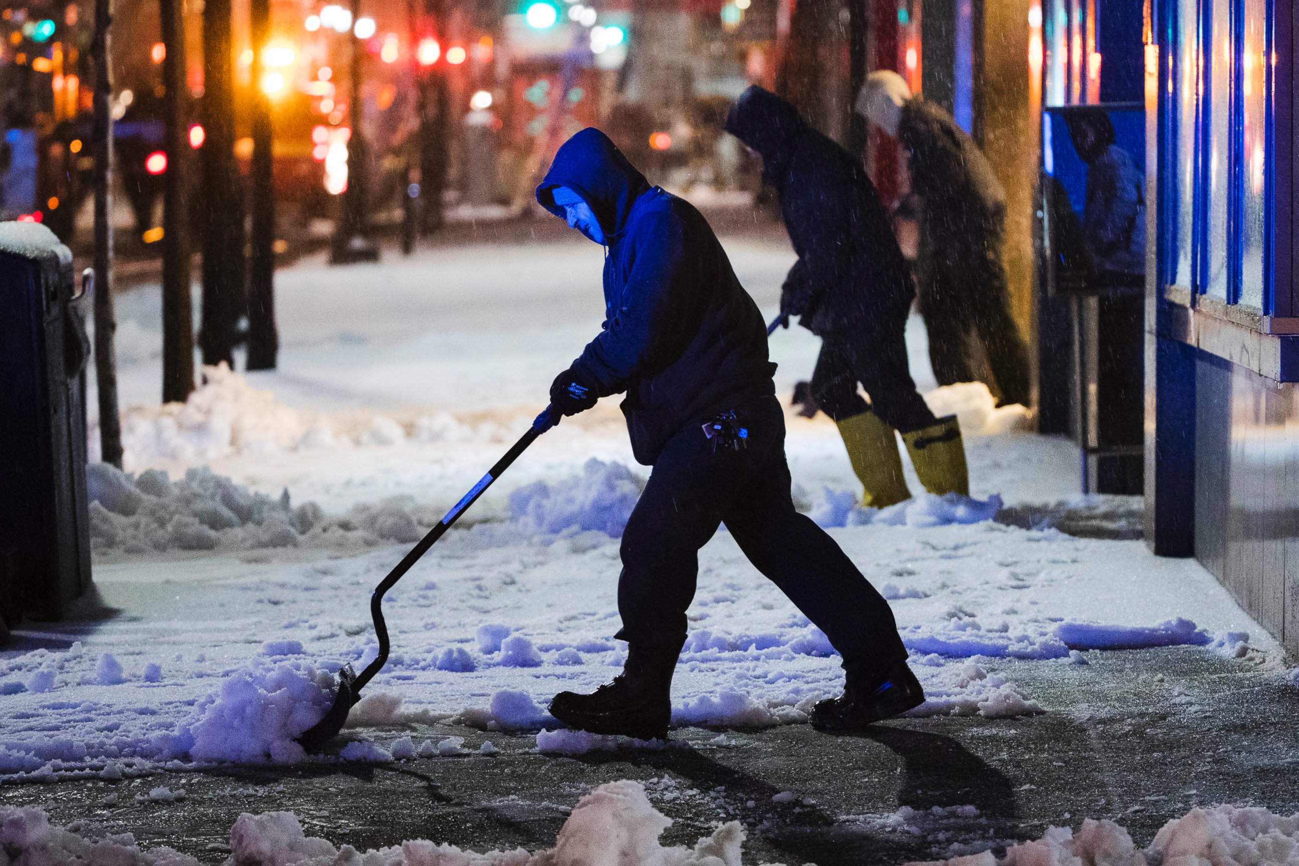 PHOTO: Workmen clear a sidewalk during a winter storm in Philadelphia, March 14, 2017.