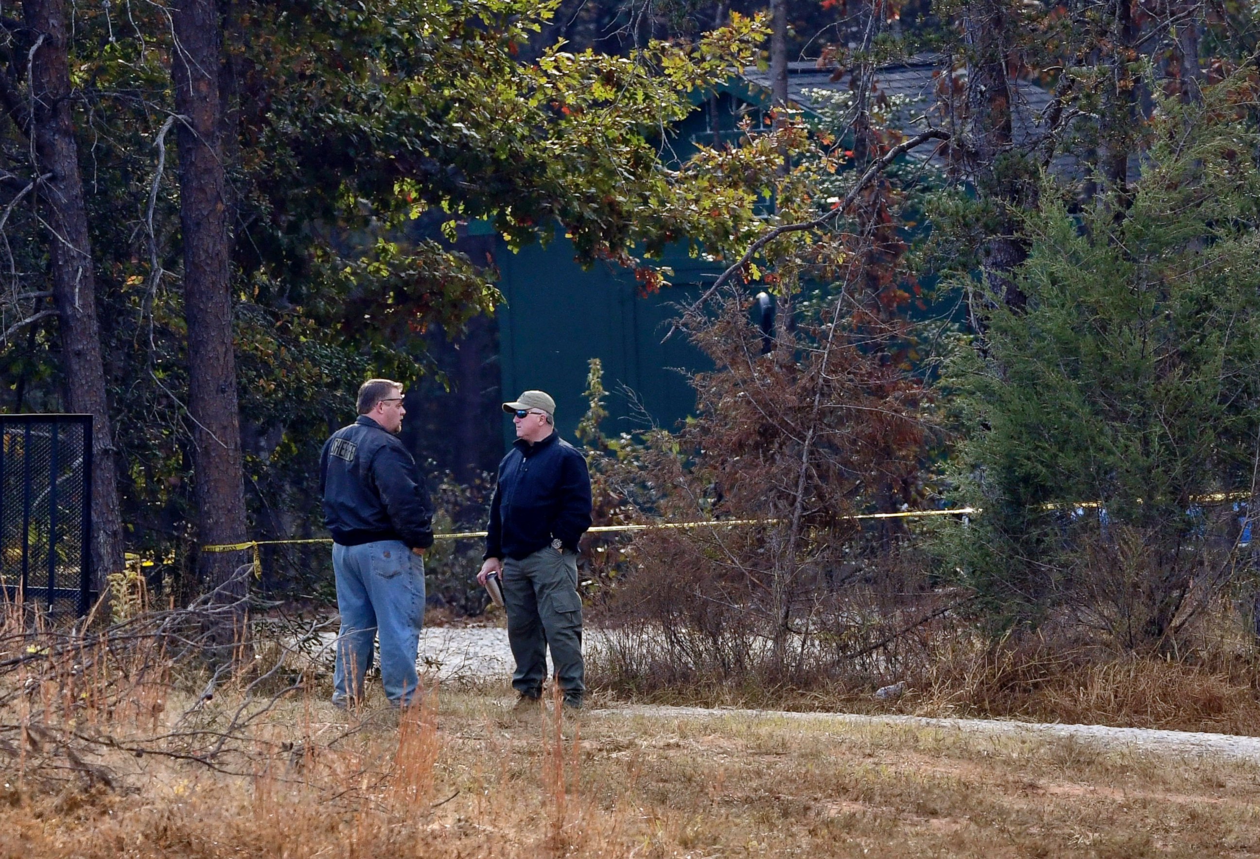 PHOTO: Law enforcement personnel stand near police tape on Todd Kohlhepp's property in Woodruff, South Carolina, Nov. 6, 2016.