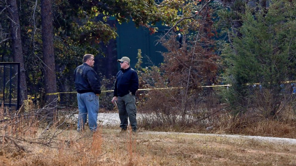 PHOTO: Law enforcement personnel stand near police tape on Todd Kohlhepp's property in Woodruff, South Carolina, Nov. 6, 2016.