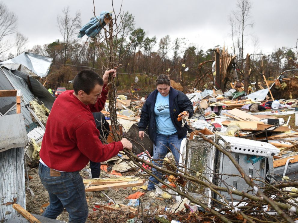 PHOTO: Chris Graves, left, and Jennifer Jeske sort through items, Nov. 30, 2016, from the remains of a mobile home where two people were killed in Polk County after a tornado swept through the area.