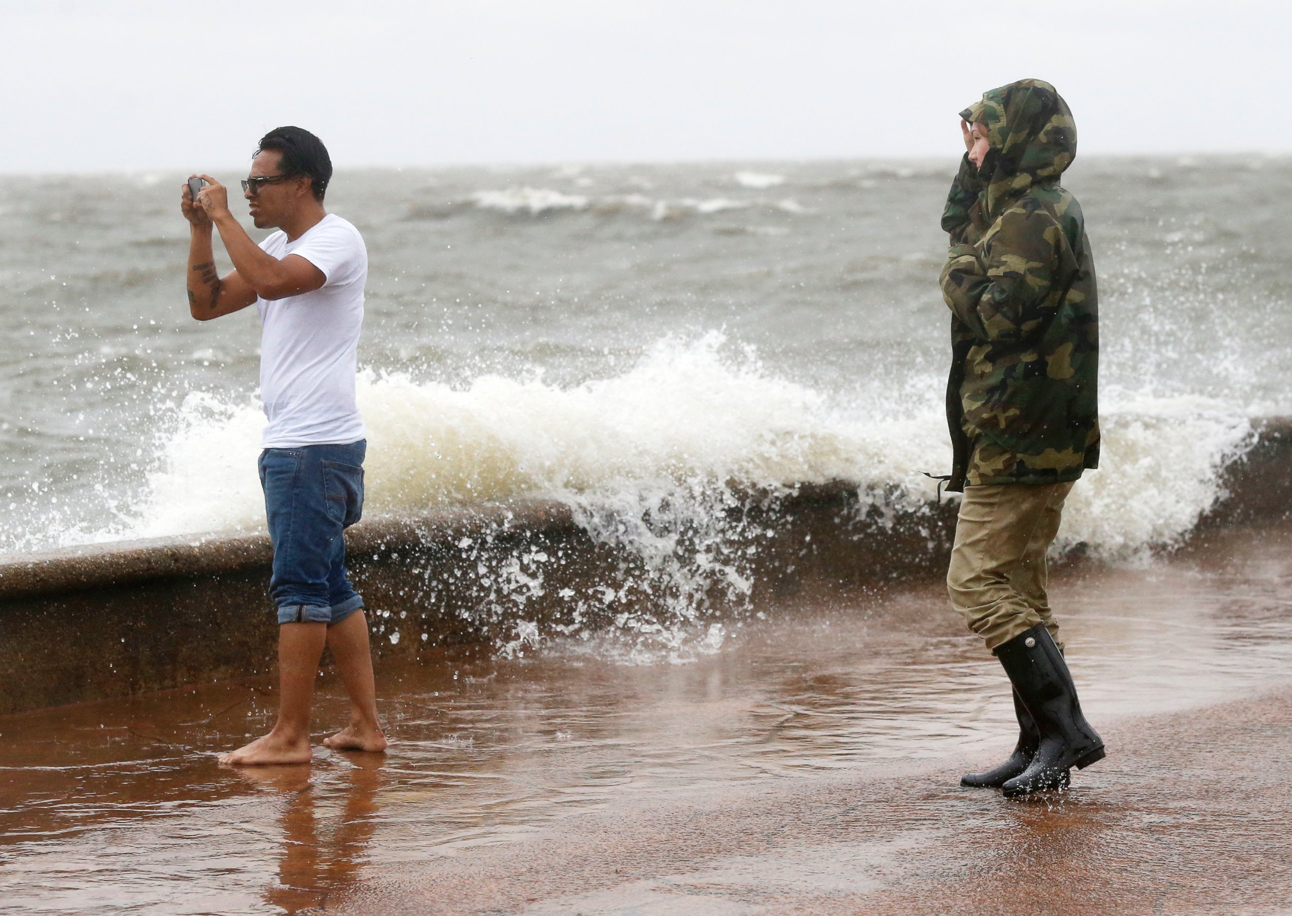 PHOTO: Julie Plaisance, right, and Renee Davila take photos on the shore of Lake Pontchartrain as weather from Tropical Storm Cindy, in the Gulf of Mexico, impacts the region in New Orleans, June 20, 2017.