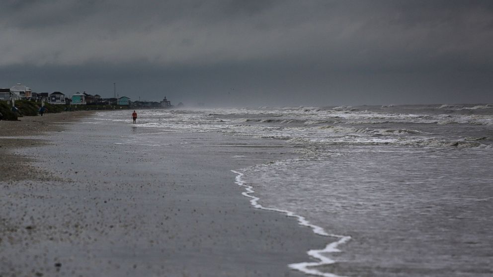 PHOTO: A woman walks along the beach the morning after Tropical Storm Cindy made landfall, June 22, 2017, on the Bolivar Peninsula, Texas.