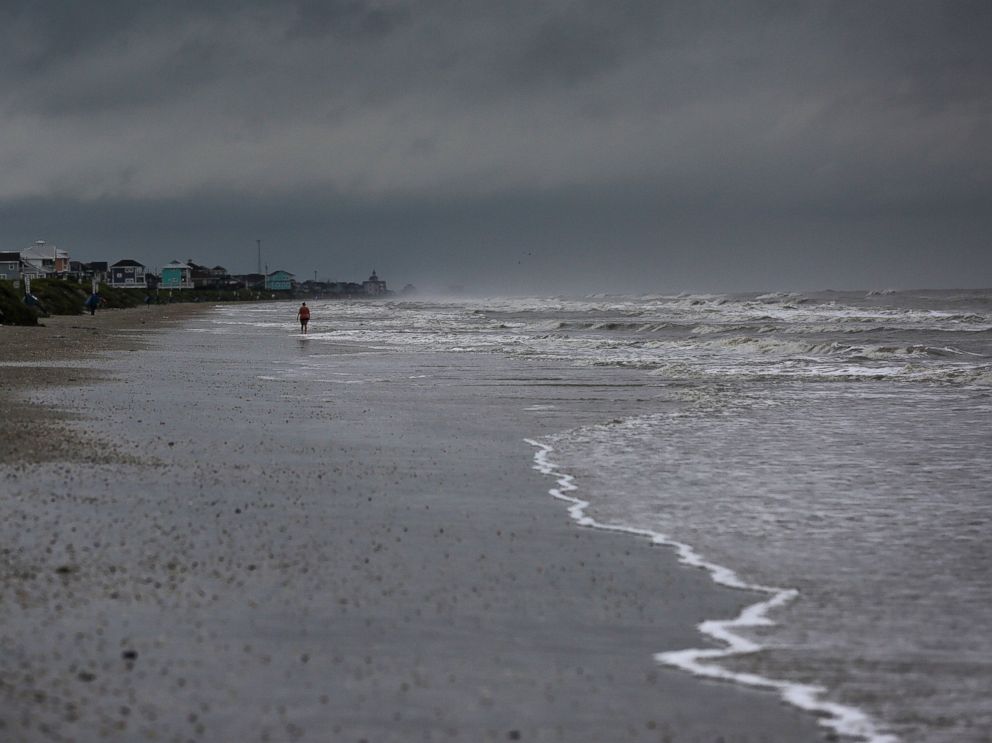 PHOTO: A woman walks along the beach the morning after Tropical Storm Cindy made landfall, June 22, 2017, on the Bolivar Peninsula, Texas.