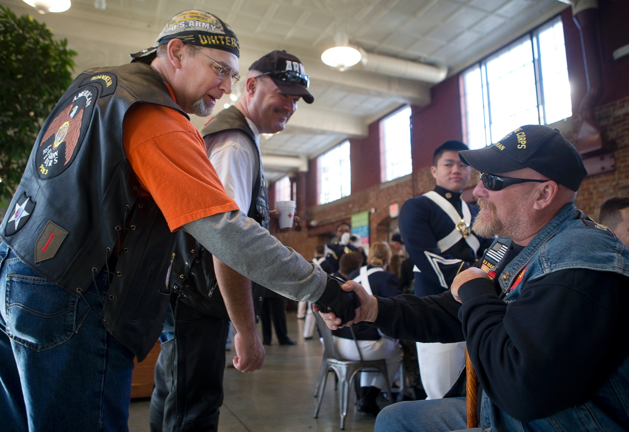 PHOTO: Joel Funk, of Salem, left, and Steve Lovelace, of Botetourt, center, both with the American Legion Riders, greet Vietnam War veteran Charles Shull of Roanoke prior to Virginia's Veterans Parade, Nov. 5, 2016, in Roanoke, Virginia. 