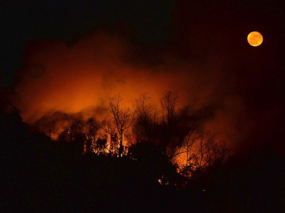 PHOTO: A wildfire burns as it approaches Bat Cave, North Carolina.