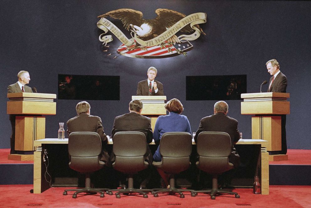 PHOTO: Democratic candidate Bill Clinton, center speaks, while Independent candidate H. Ross Perot, left and U.S. President George Bush look on, during the first debate in St. Louis, Oct. 11, 1992.