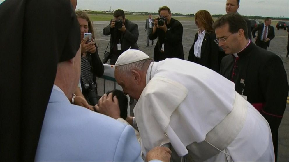 PHOTO: Pope Francis kisses a boy in wheelchair after arriving at Philadelphia International Airport in Philadelphia, Sept. 26, 2015.