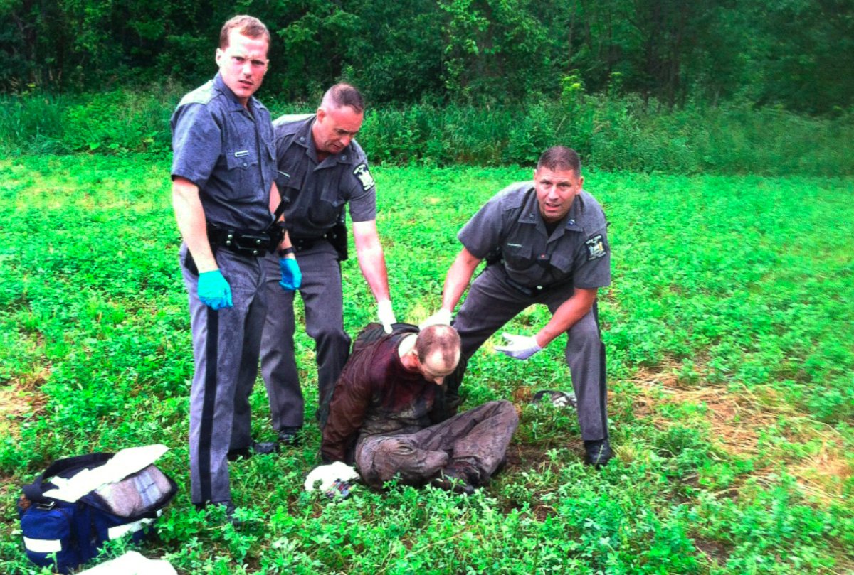 PHOTO: Police stand over David Sweat after he was shot and captured near the Canadian border Sunday, June 28, 2015, in Constable, N.Y.