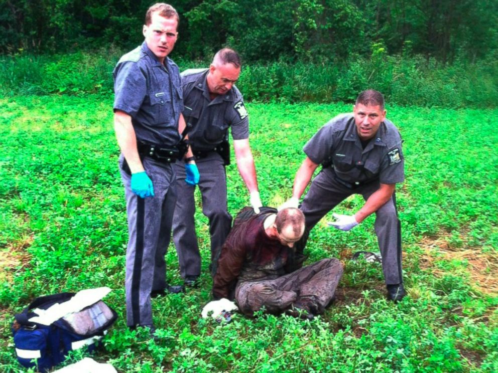PHOTO: Police stand over David Sweat after he was shot and captured near the Canadian border Sunday, June 28, 2015, in Constable, N.Y.