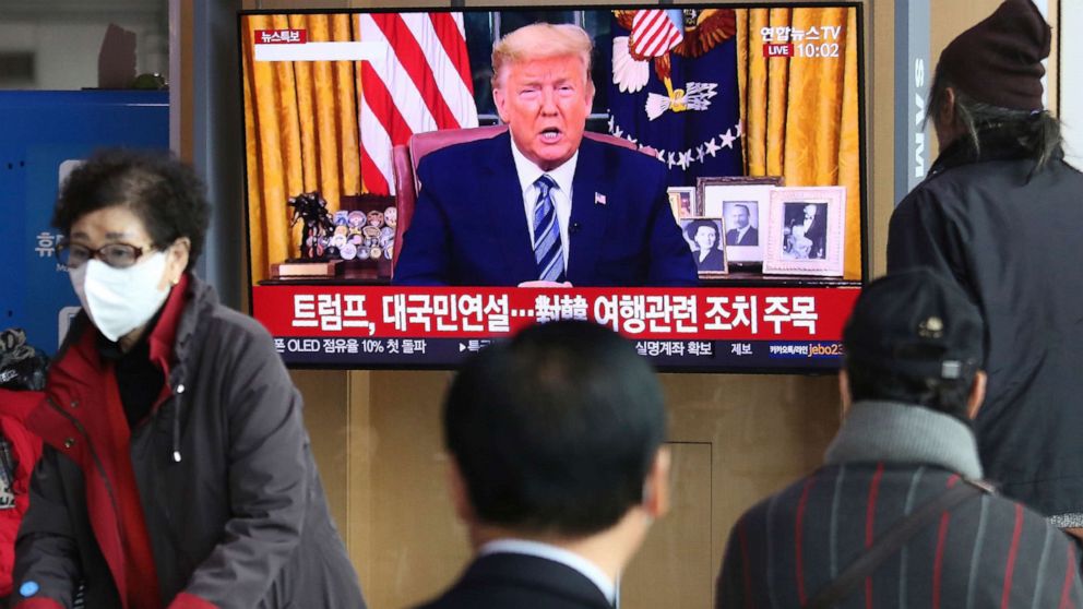PHOTO: People watch a TV screen showing a live broadcast of U.S. President Donald Trump's speech at the Seoul Railway Station in Seoul, South Korea, Thursday, March 12, 2020. Trump announced he is cutting off travel from Europe to the U.S.