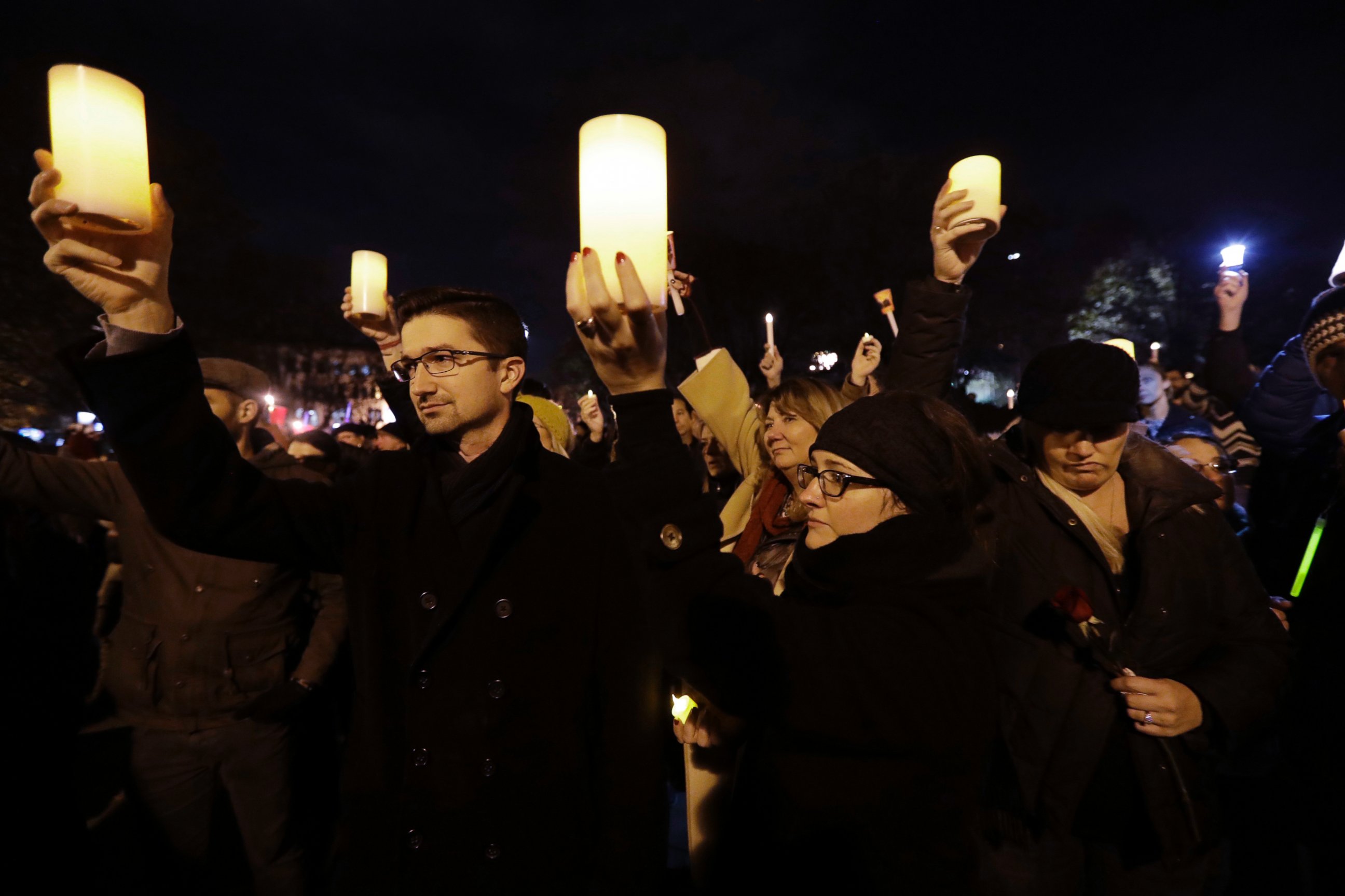 Relatives of Travis Hough hold candles during a vigil in memory of victims of a warehouse fire at Lake Merritt on Monday, Dec. 5, 2016, in Oakland, Calif.